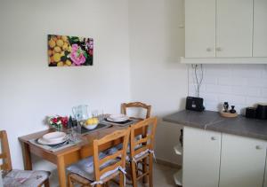 a kitchen with a wooden table with chairs and a tableablish at Lemon House in Neo Klima