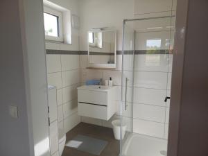a bathroom with a toilet and a glass shower at Privatzimmer an der Büffelweide in Gmünd