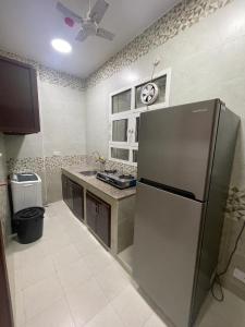 a kitchen with a stainless steel refrigerator in it at Red-15 - Bn Saif in Salalah