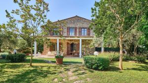 a brick house with trees in the yard at San Martino in Certaldo