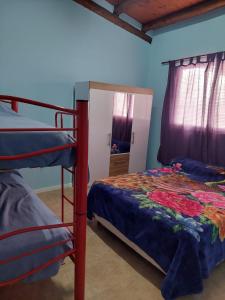 a bedroom with two bunk beds and a mirror at Alojamiento Los Imigrantes in Chajarí