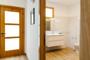 a bathroom with a sink and a toilet at Panphilia: Holiday Apartment in Vasto +23 photos