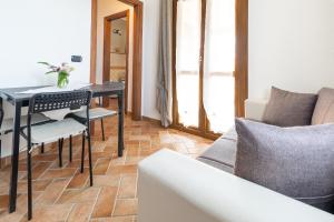 a living room with a table and a couch at Carìgnu in Tortolì