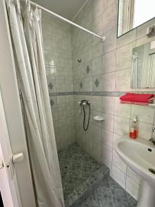 a bathroom with a shower and a sink at Lelle Beach Club in Balatonlelle