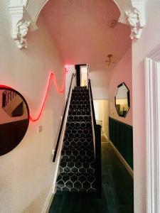 an escalator in a building with a red line on the wall at Quirky House Blackpool in Blackpool