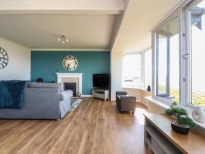 a living room with a couch and a tv at Flat 3, Sandridge Court in Fleetwood