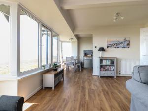 a living room with hardwood floors and large windows at Flat 3, Sandridge Court in Fleetwood