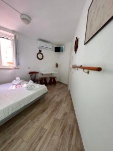a small room with a bed and a table at Casa del Capitano - Suite Mediterraneo in Ponza +25 photos