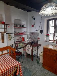 a kitchen with a table and a stove in it at Harmat Porta in Galambok