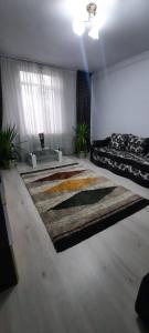 a bedroom with a bed and a large rug at Apartament La Denis in Bîrlad