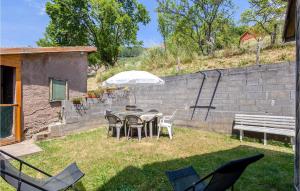a patio with a table and chairs and an umbrella at Amazing Home In Natzwiller With Wifi in Natzwiller