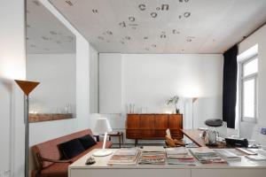 a living room with a table with books on it at Casa do Conto - Arts & Residence in Porto
