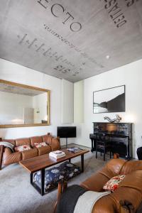 a living room with a couch and a piano at Casa do Conto - Arts & Residence in Porto +53 photos
