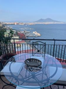 einen Glastisch auf dem Balkon mit Meerblick in der Unterkunft Panoramico a Posillipo in Neapel