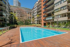 an empty swimming pool in the middle of a building at Luxury Apartments in Puerto Madero in Buenos Aires