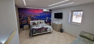 a bedroom with a bed and a painting on the wall at Fashion House Napoli in Naples