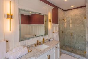a bathroom with a sink and a shower at Orman Mansion - Pueblo's Most Luxurious Stay! in Pueblo