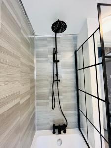 a shower with a shower head in a bathroom at Quirky House Blackpool in Blackpool