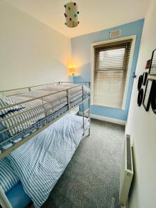 een slaapkamer met een stapelbed en een raam bij Quirky House Blackpool in Blackpool
