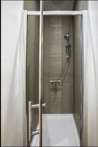 a shower with a glass door in a bathroom at Abingdon House Workstays UK in Middlesbrough