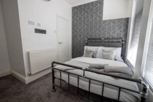 a bedroom with a bed with a metal frame at Abingdon House Workstays UK in Middlesbrough