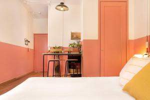 een slaapkamer met roze en oranje muren en een bed bij Hotel San Fernando in Mexico-Stad