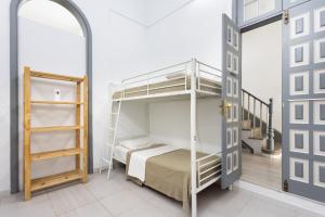 a bedroom with a bunk bed and a ladder at Wanderlust Hostel in Santa Cruz de Tenerife +57 photos