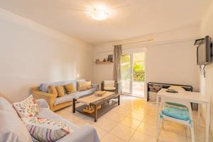 a living room with a couch and a table at Thalassa Apartments in Kallithea Halkidikis