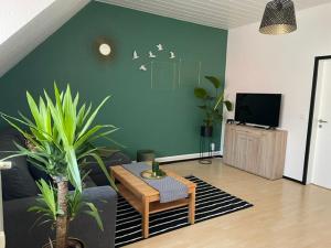 a living room with a couch and a table and a tv at Ferienwohnung Unter den Linden in Halbe