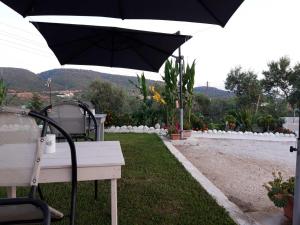 a black umbrella sitting on top of a table at Apartments dimitra in Kanallákion +2 photos