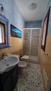 a bathroom with a sink and a toilet and a shower at Antica Tonnara in Favignana
