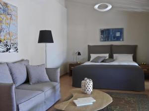 a bedroom with a bed and a couch and a table at Scalarea Estate Residences in Skalánion