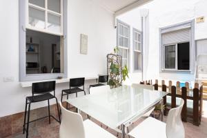 a dining room with a glass table and chairs at Wanderlust Hostel in Santa Cruz de Tenerife