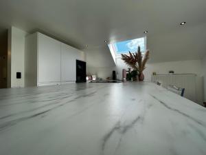 a large white room with a marble floor at Le NY de JADE in Stoumont