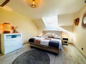 a bedroom with a bed and a skylight at Le NY de JADE in Stoumont