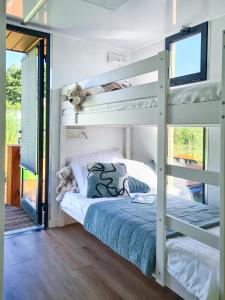 a bedroom with bunk beds in a house at SunRise HouseBoats in Łazy