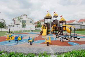 a park with a playground with slides and swings at Desaru 16Pax Family with Private Mini Pool & Jacuzzi in Kota Tinggi