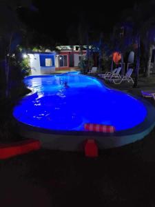 a large blue swimming pool at night at Agua Del Caribe in Sosúa