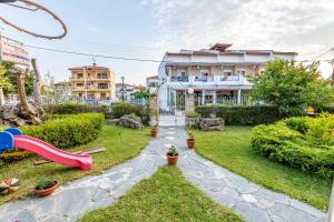 a yard with a slide and a playground at Thalassa Apartments in Kallithea Halkidikis