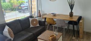 a living room with a couch and a table at The Flower Fields in Lisse