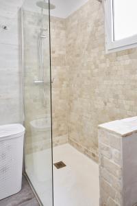a bathroom with a glass shower with a sink at City Center Penthouse with Solarium 2 minutes from the Beach in Fuengirola
