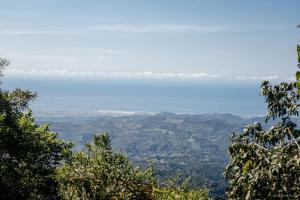 a view from the top of a mountain with trees at Pueblo del Sol Hotel Retreat in Puerto Escondido