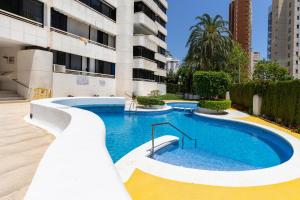 a swimming pool in front of a building at Mediterranean Blue by Fidalsa in Benidorm