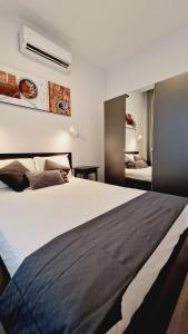 a bedroom with a large white bed with at La Promesa in Madrid