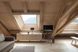 a living room with a couch and a tv in a attic at Haus Hof 30 in Schwarzenberg