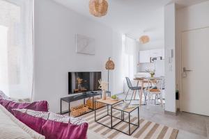 a living room with a couch and a table at La Bouverie in Romans-sur-Isère