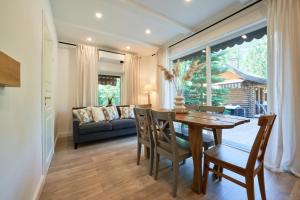 a dining room with a table and chairs and a couch at Luxury villas Kaunas in Šlienava