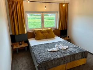 a bedroom with a bed with two swans on it at Jaśminowa Park in Zator