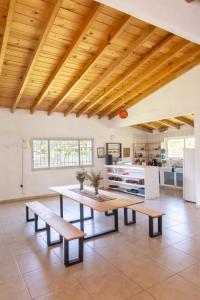 uma cozinha com uma mesa e bancos num quarto em Casa Hostal- Cozy Calpulli em Valle de Bravo