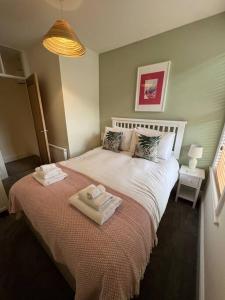 a bedroom with a bed with two towels on it at Gorgeous home in Hebden Bridge in Hebden Bridge